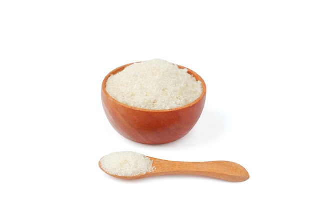 Granulated sugar with wooden bowl and spoon on white background