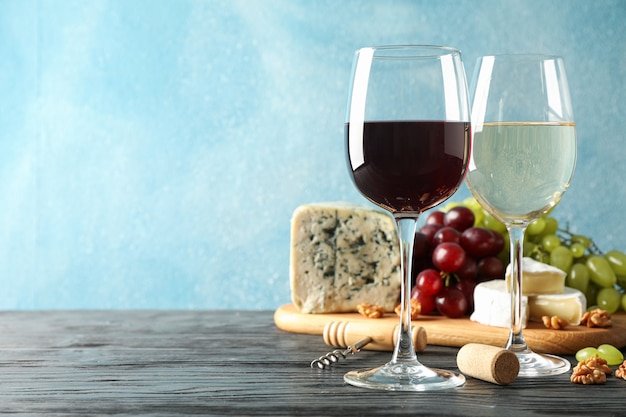 Grape, cheese, corkscrew, glasses with wine