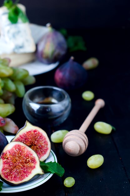 Grape and figs with on wooden table background.