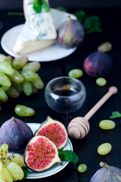 Grape and figs with on wooden table background.