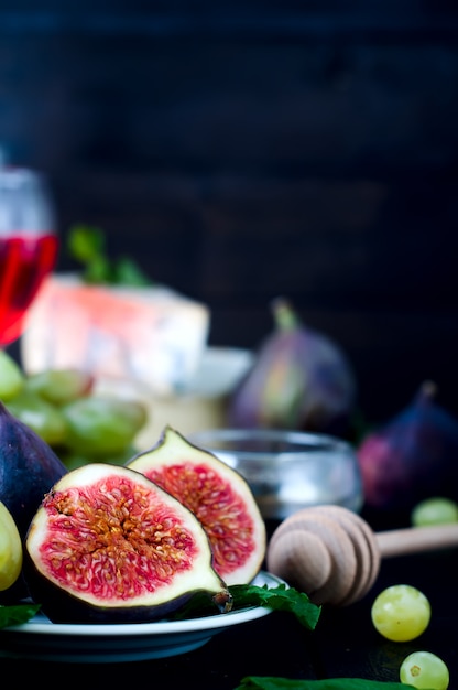 Grape and figs with on wooden table background.