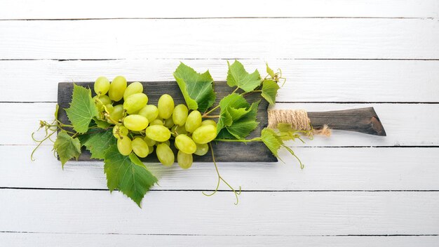 Grape Fresh white grapes on a white wooden background Top view Free space for text