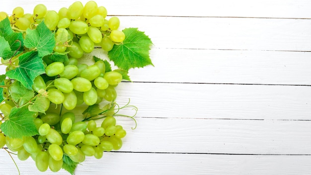 Grape Fresh white grapes on a white wooden background Top view Free space for text