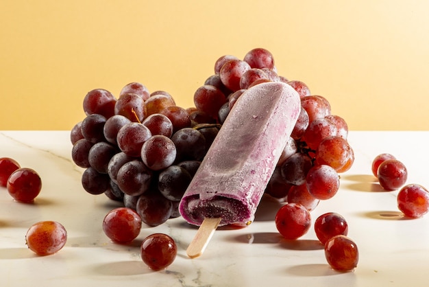 Grape ice cream on bunches of grapes on white background