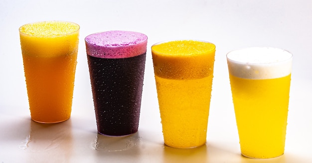 Grape juice, orange juice, pineapple juice and passion fruit juice, fresh and iced - healthy drinks on white background