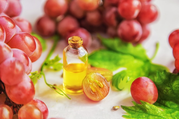 Grape seed oil in a bottle. Selective focus.