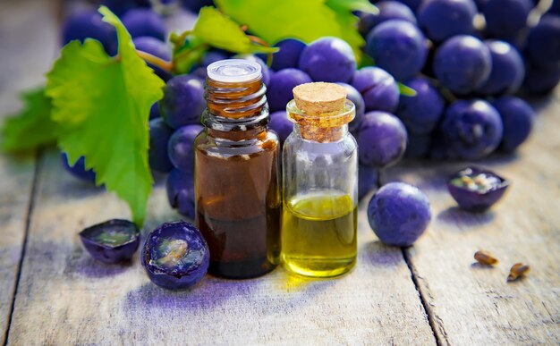 Grape seed oil in a small jar. Selective focus.