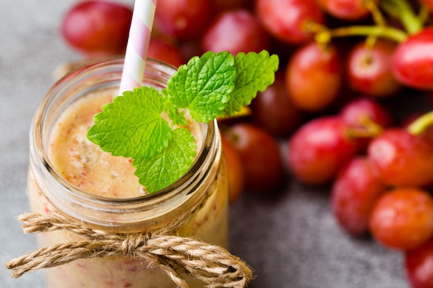 Grape smoothie, on the grey  table.