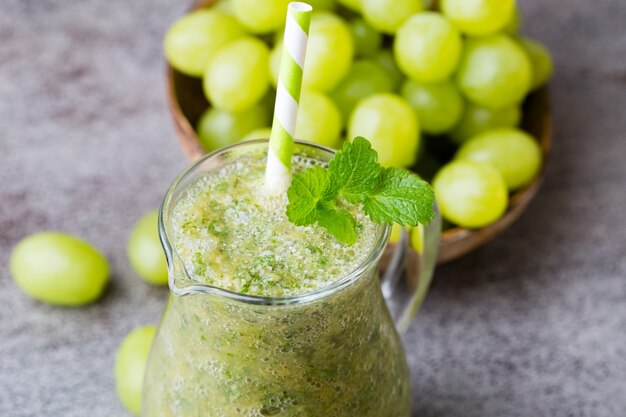 Grape smoothie, on the grey  table.