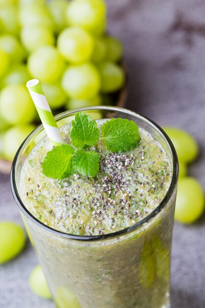 Grape smoothie, on the grey  table.