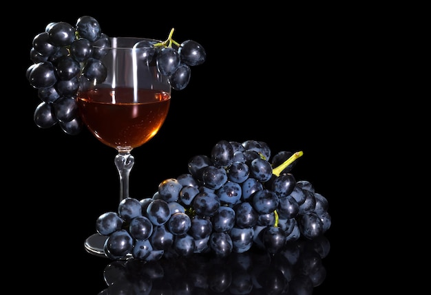 Grape wine and a bunch of grapes on a black background