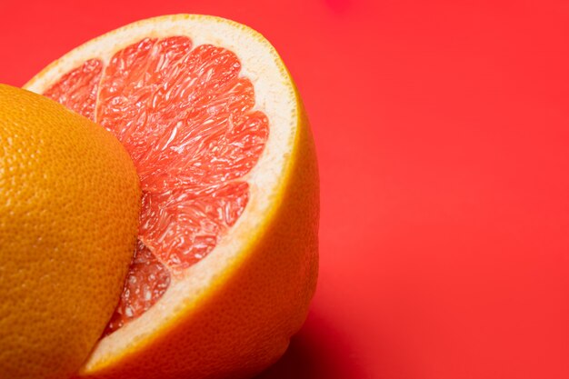 Grapefruit in tweeën gesneden op levendig rood oppervlak