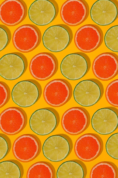 Grapefruit and lime pattern on yellow background. minimal flat lay concept. print