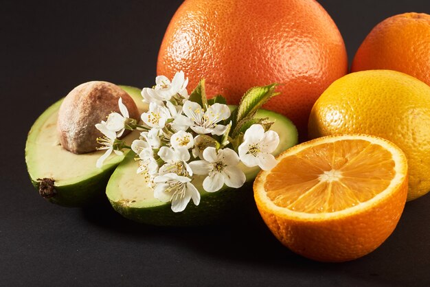 Grapefruit, orange and avocado, isolated on a black.