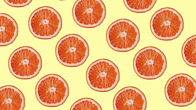 Photo grapefruit pattern on yellow background. minimal flat lay concept. top view