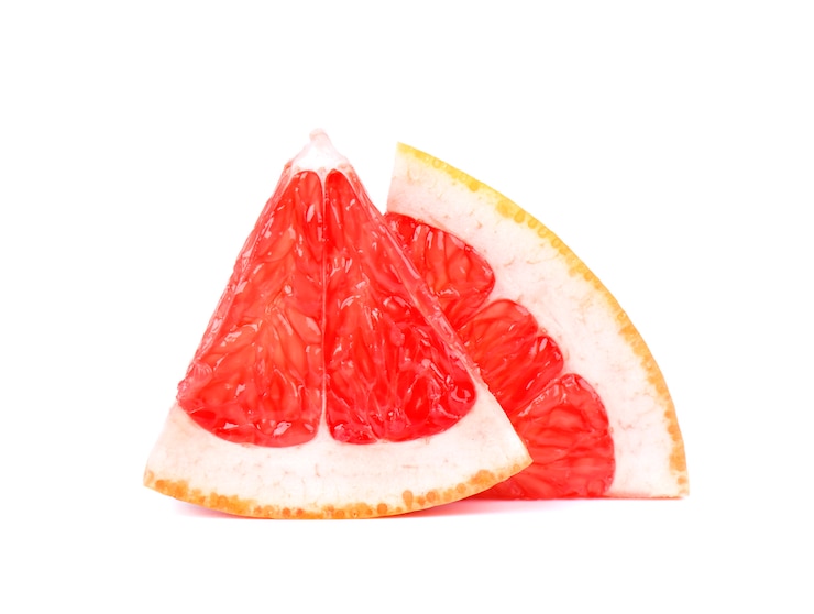 Photo grapefruit piece isolated on white space. fresh fruit. with clipping path. fresh grapefruit with green leaves isolated.