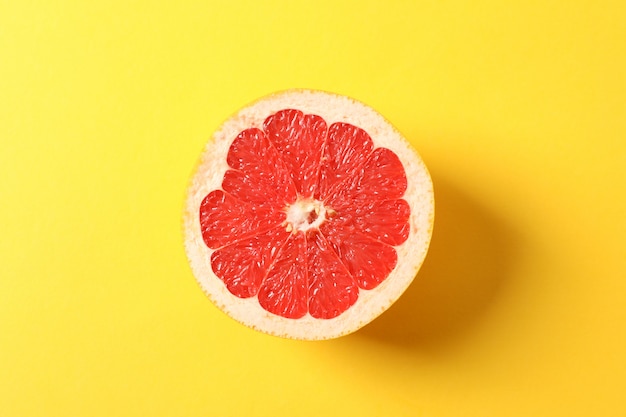 Grapefruit slice on yellow space for text