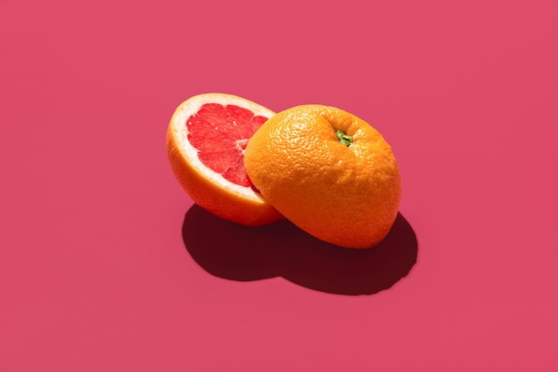 Grapefruit sliced in half isolated on a magenta background