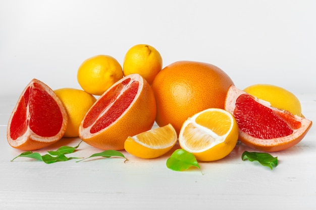 Grapefruit with slices on a wooden table.