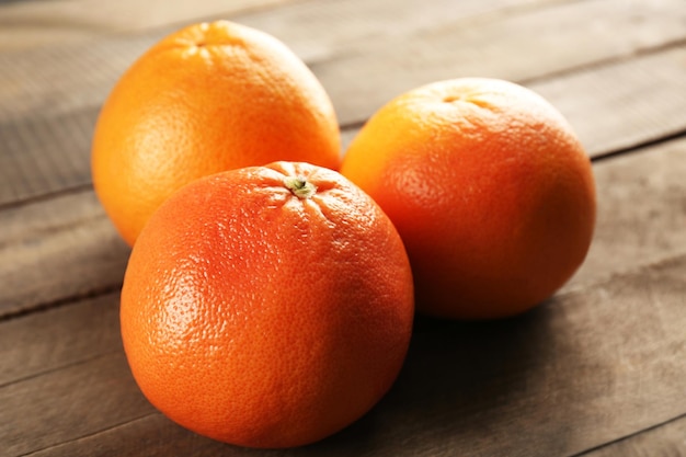 Grapefruits on wooden background close up