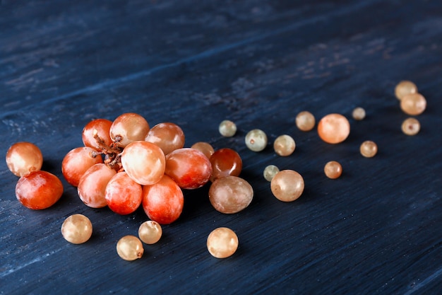 Grapes on dark blue wooden table closeup