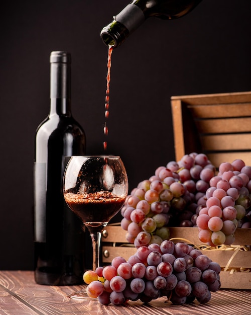 Grapes details of beautiful grapes and wine on rustic wooden table selective focus