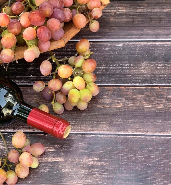 grapes and wine close-up on a wooden background