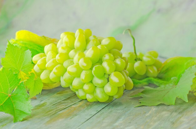 Grapes on a wooden table close-up. 