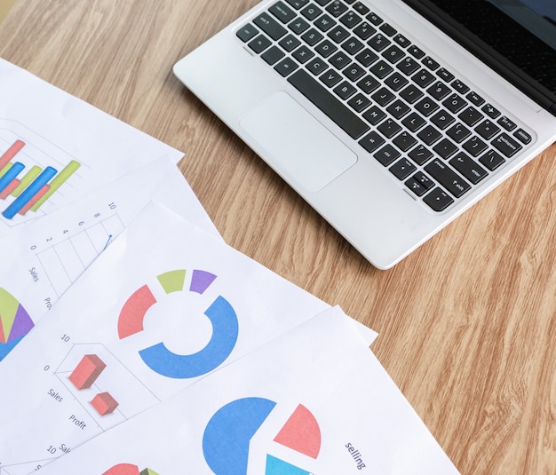 Graph on the desk analysis and laptop with business