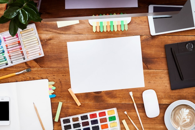 Graphic  creative table concept, computer paints on brown wooden desk