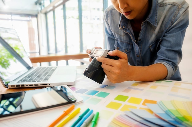 Graphic design and color swatches and pens on a desk.