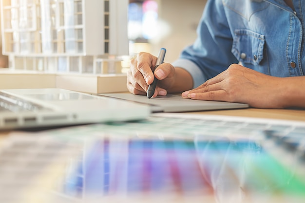 Graphic design and color swatches and pens on a desk. 