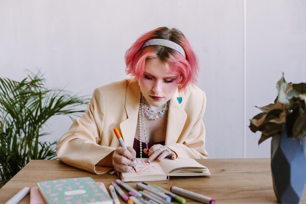 Graphic designer girl red color hair sketching at table