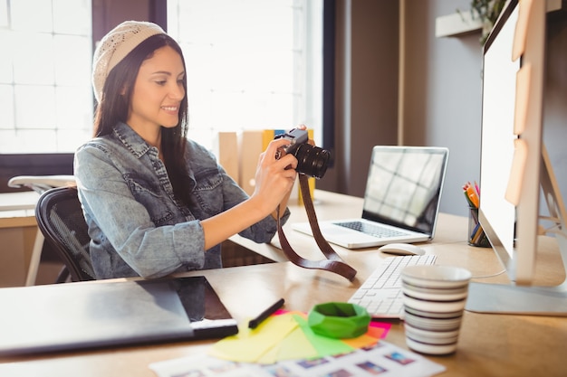 Graphic designer looking at pictures in digital camera