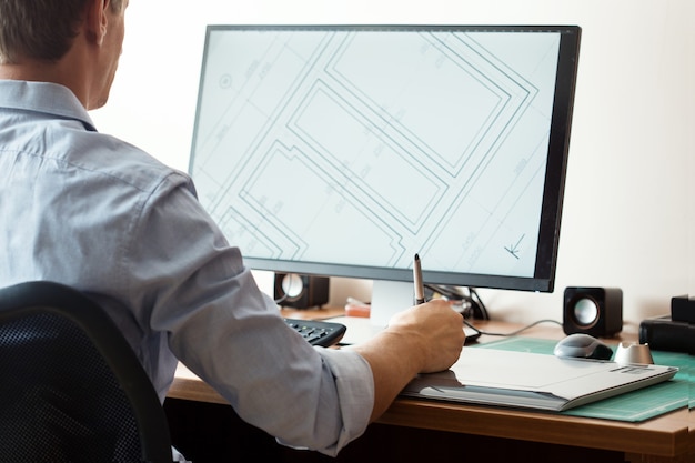 Photo graphic designer using digital tablet and computer in office or home