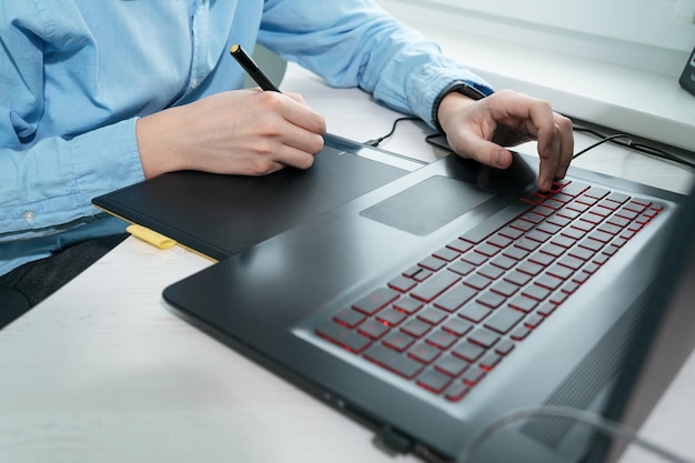 Graphic designer using digital tablet and computer