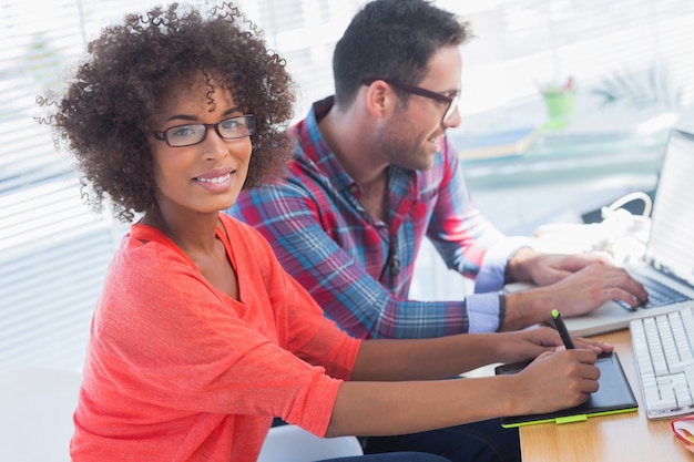 Graphic designer using a graphics tablet in her office