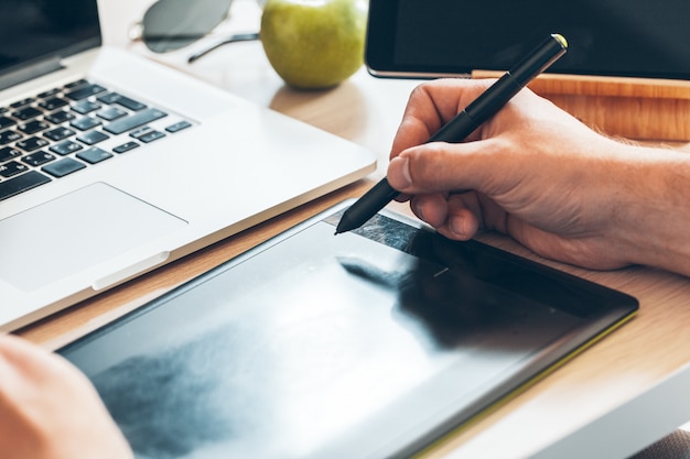 Graphic designer using a pen tablet