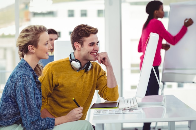 Graphic designer wearing headphones at desk