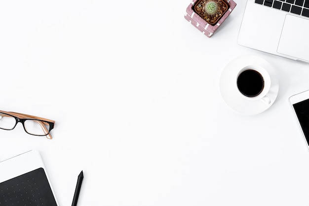 Graphic Designer white work table with computer, cactus, coffee, phone and pen