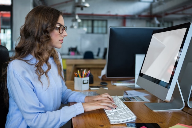 Graphic designer working over computer at desk