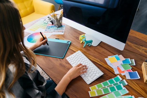 Photo graphic designer working at desk