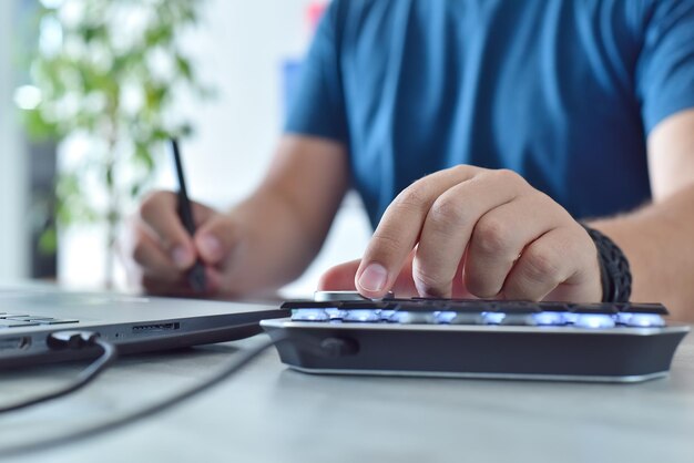 Graphic designer working in office with digital control wheel keyboard