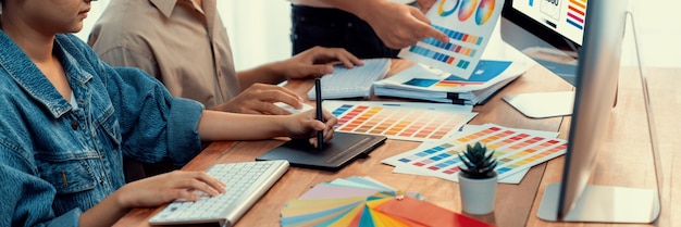 Graphic designer works on computer laptop with digital pen Scrutinize