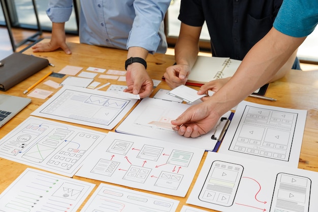 Graphic designers work together with UX UI designer planning application