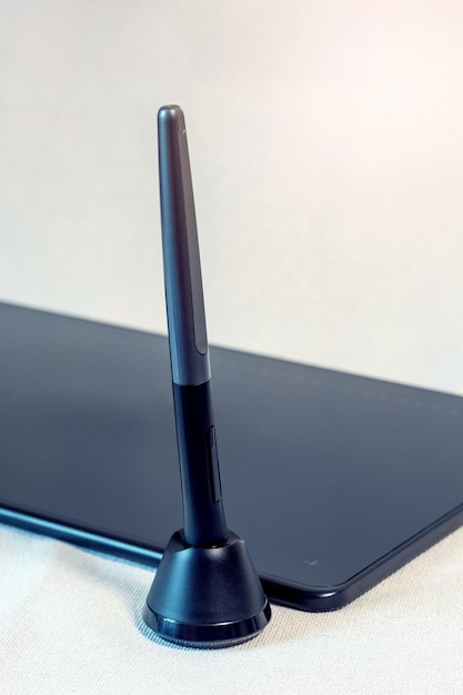 Graphic tablet and pen stylus with stand on a light background