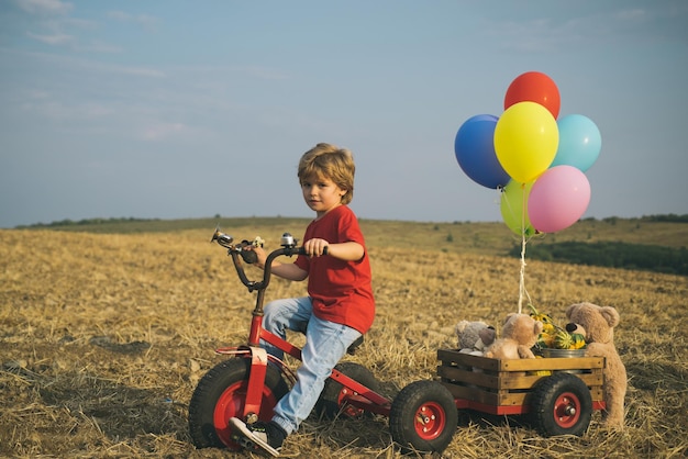 Grappig kind met vintage fiets in een landwegreis en vakantieconcept kinderdroom van reizen