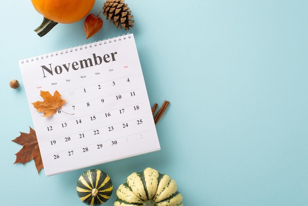 Grasp the essence of autumns harvest Top view reveals calendar and fall attributes on light blue isolated background allowing space for text or advertising to resonate with the seasonal concept