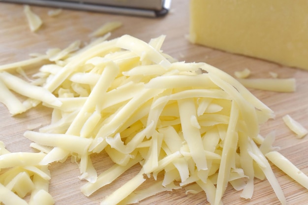 Grated cheese on a bamboo cutting board