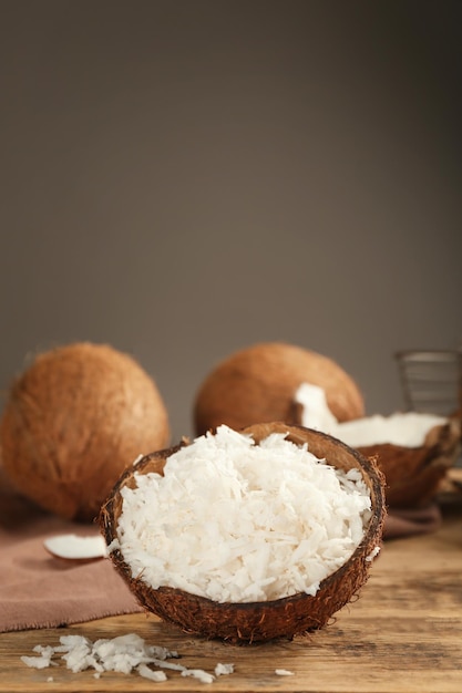 Grated coconut in shell on wooden table